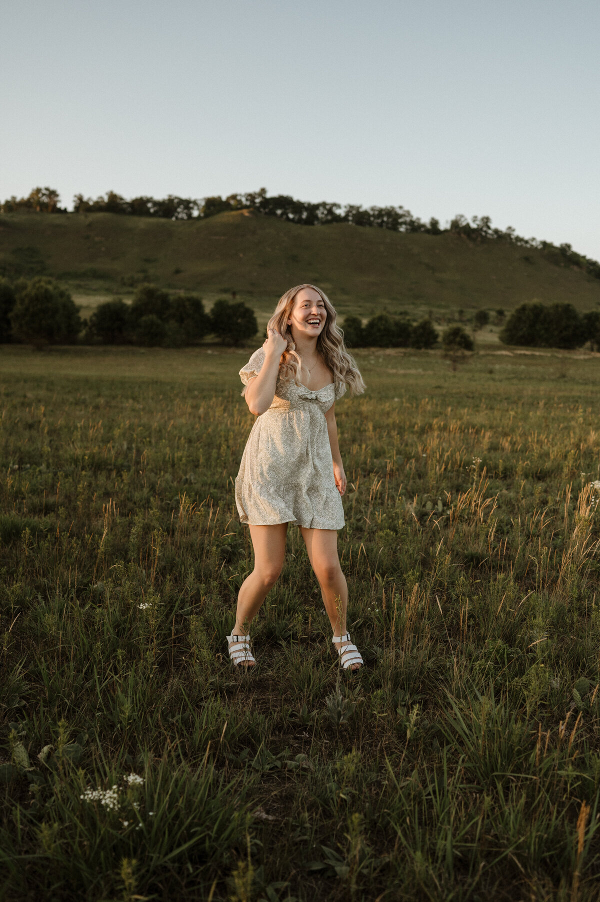 Girl dancing and laughing in field