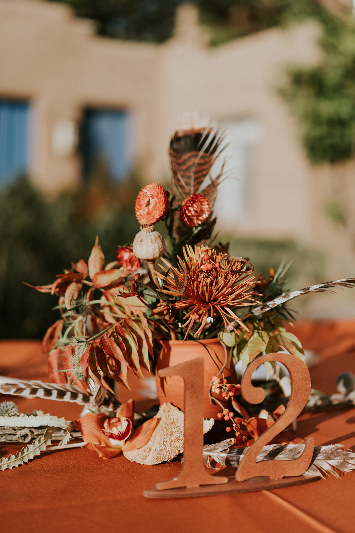 Orange and terracotta wedding centerpiece.