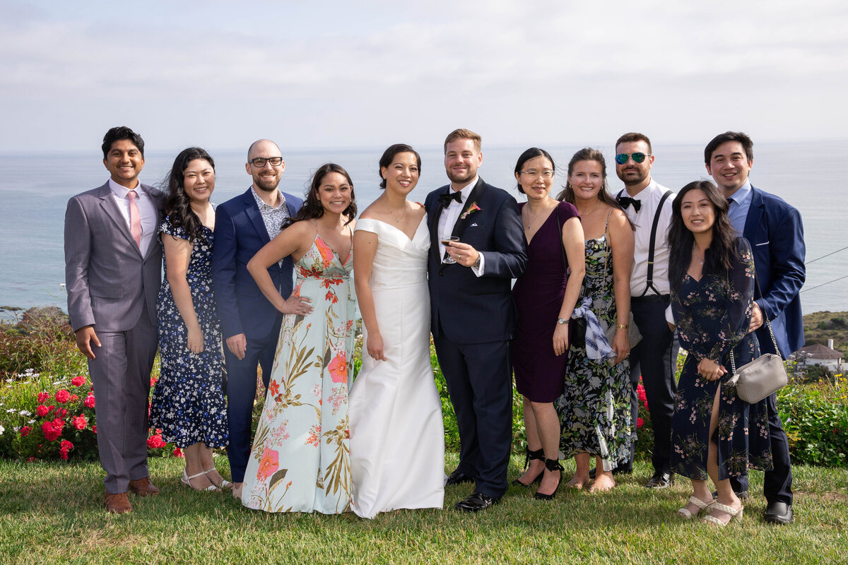 Group of guest taking a photos with the bride and groom