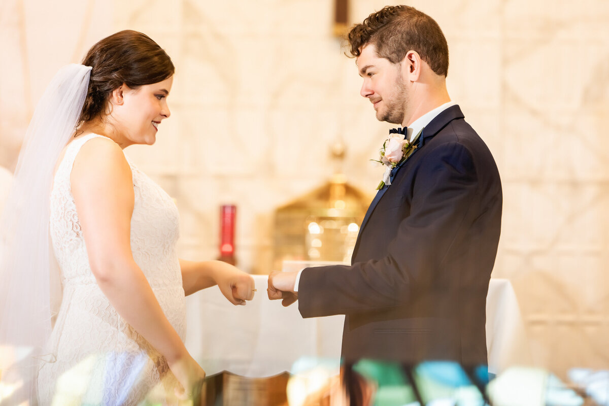 Couple fist-bumping at the altar during their wedding ceremony