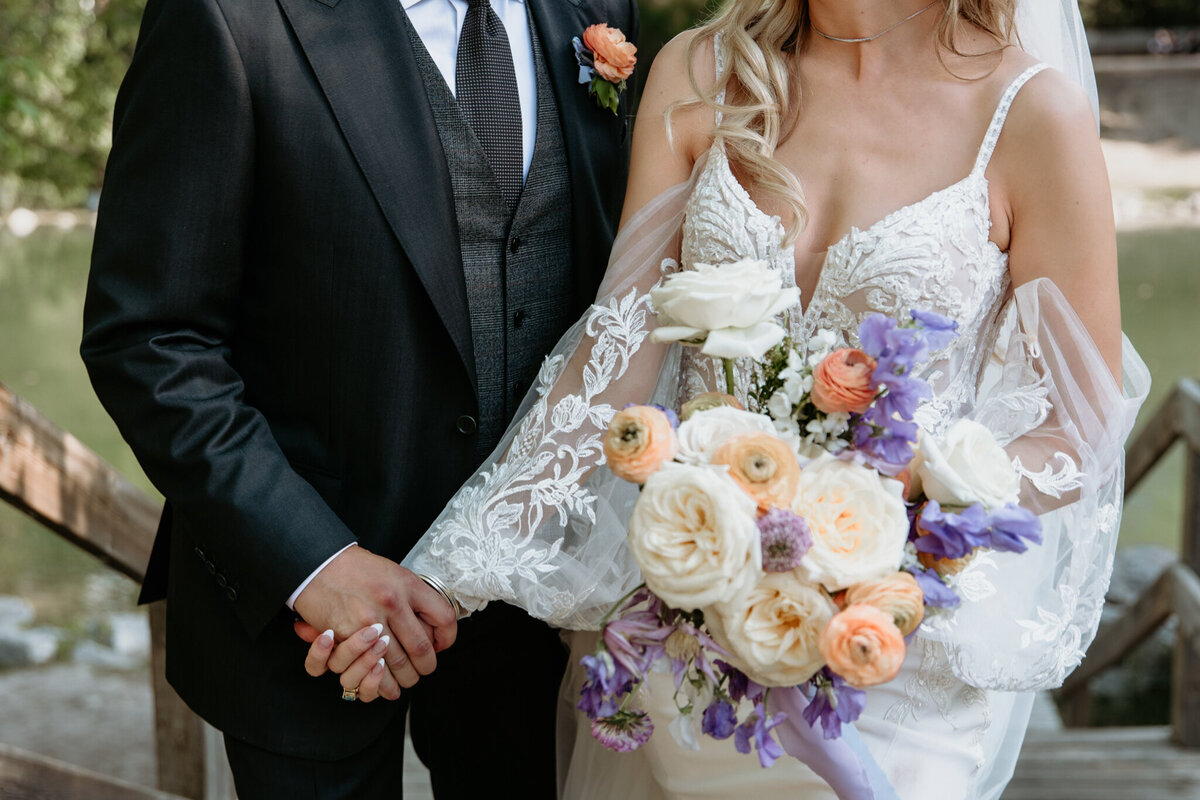 Purple and peach, spring-inspired ceremony florals by The Romantiks, romantic wedding florals based in Calgary, AB & Cranbrook, BC. Featured on the Brontë Bride Vendor Guide.