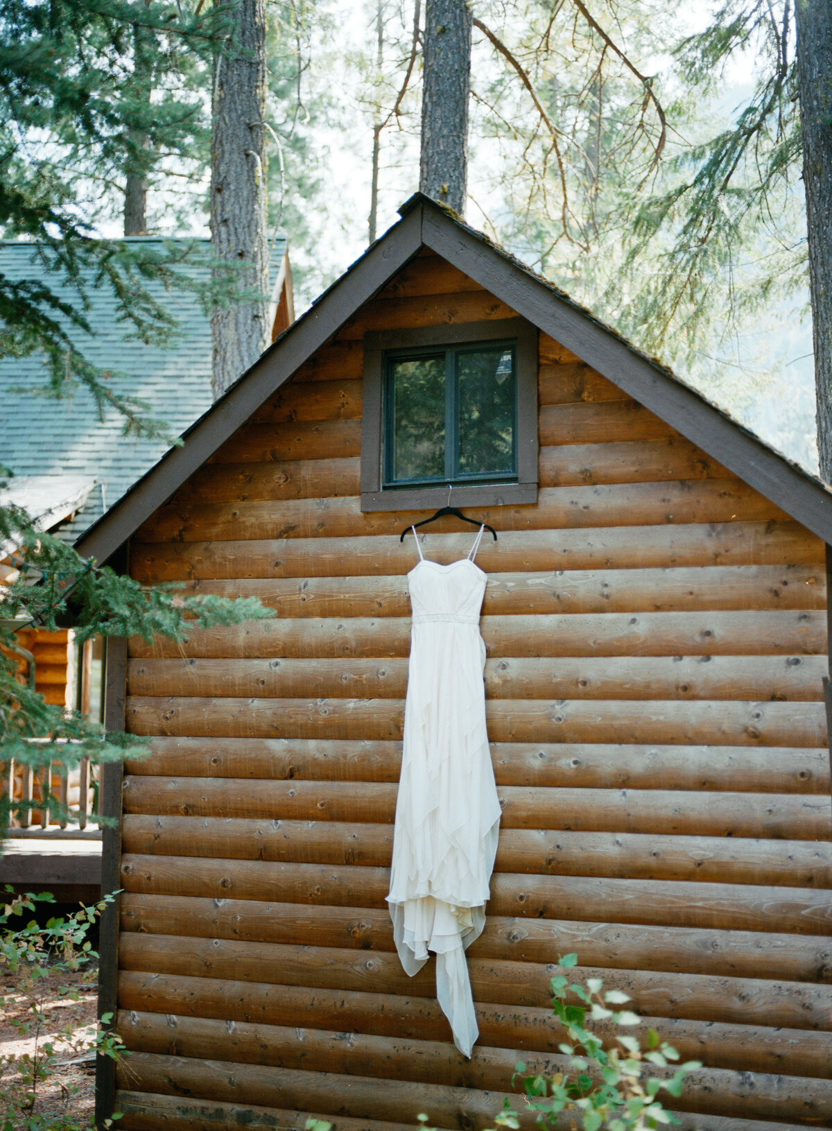 Brides wedding dress hung up on cabin