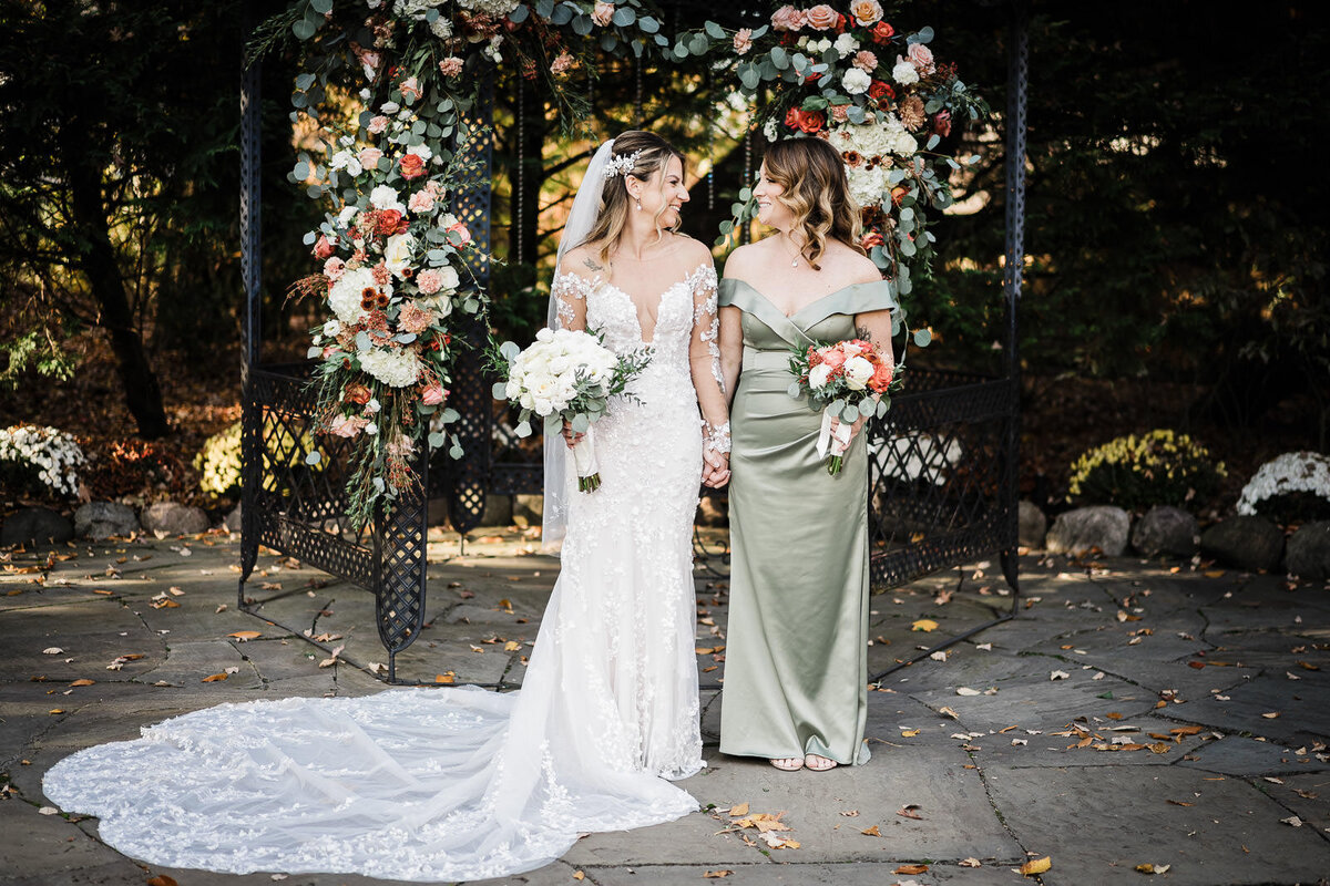 Bride sharing genuine moment with maid of honor on wedding day, emotional documentary photography by Alex Kaplan in Northern NJ