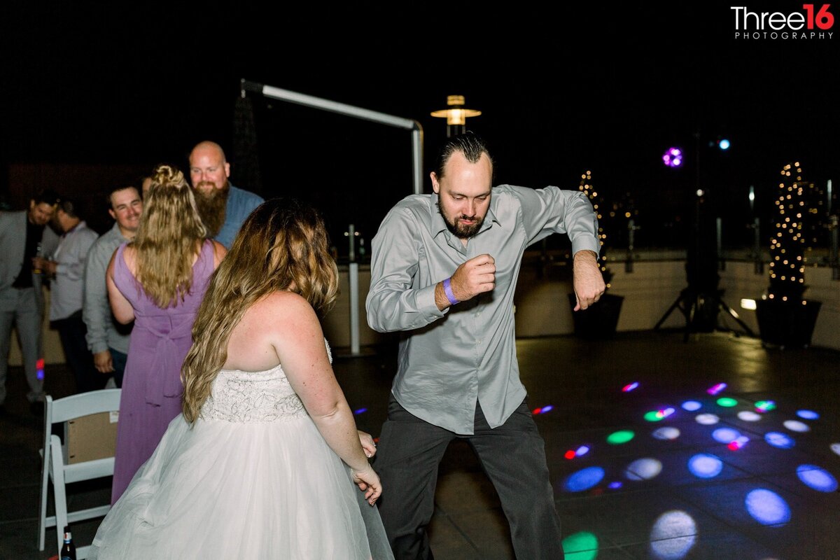 Bride dances with a wedding guest at the reception