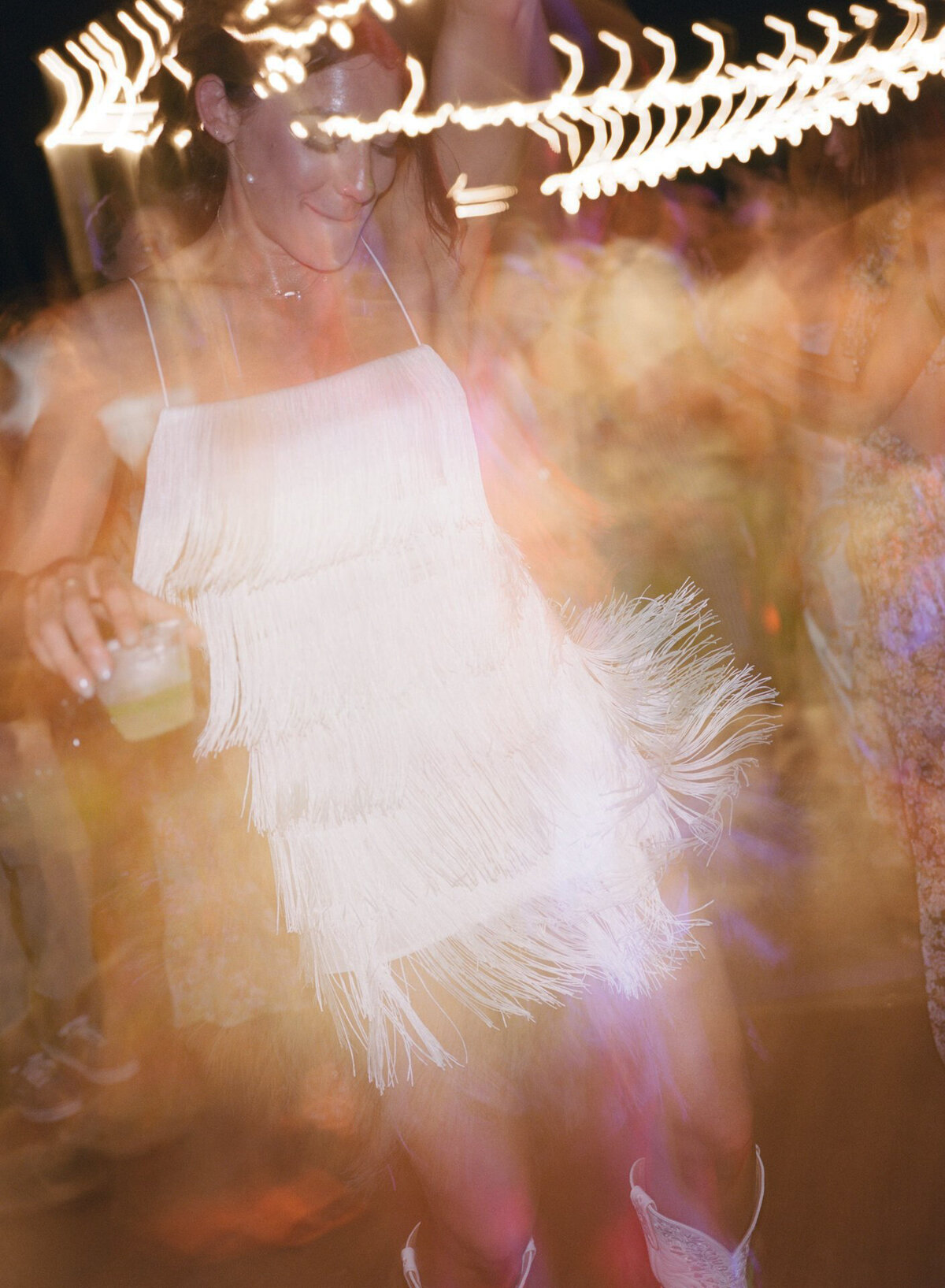Abstract, blurry film image of a bride dancing, captured in a documentary wedding photography style — Carmel wedding photography by Kate Winters Photography.