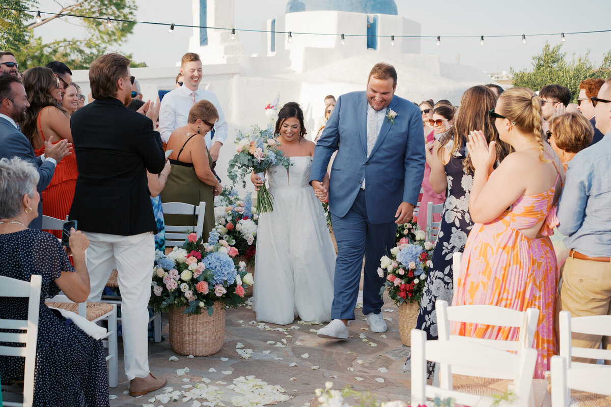 bride and groom walking down the aisle at a destination island wedding on Paros, Greece
