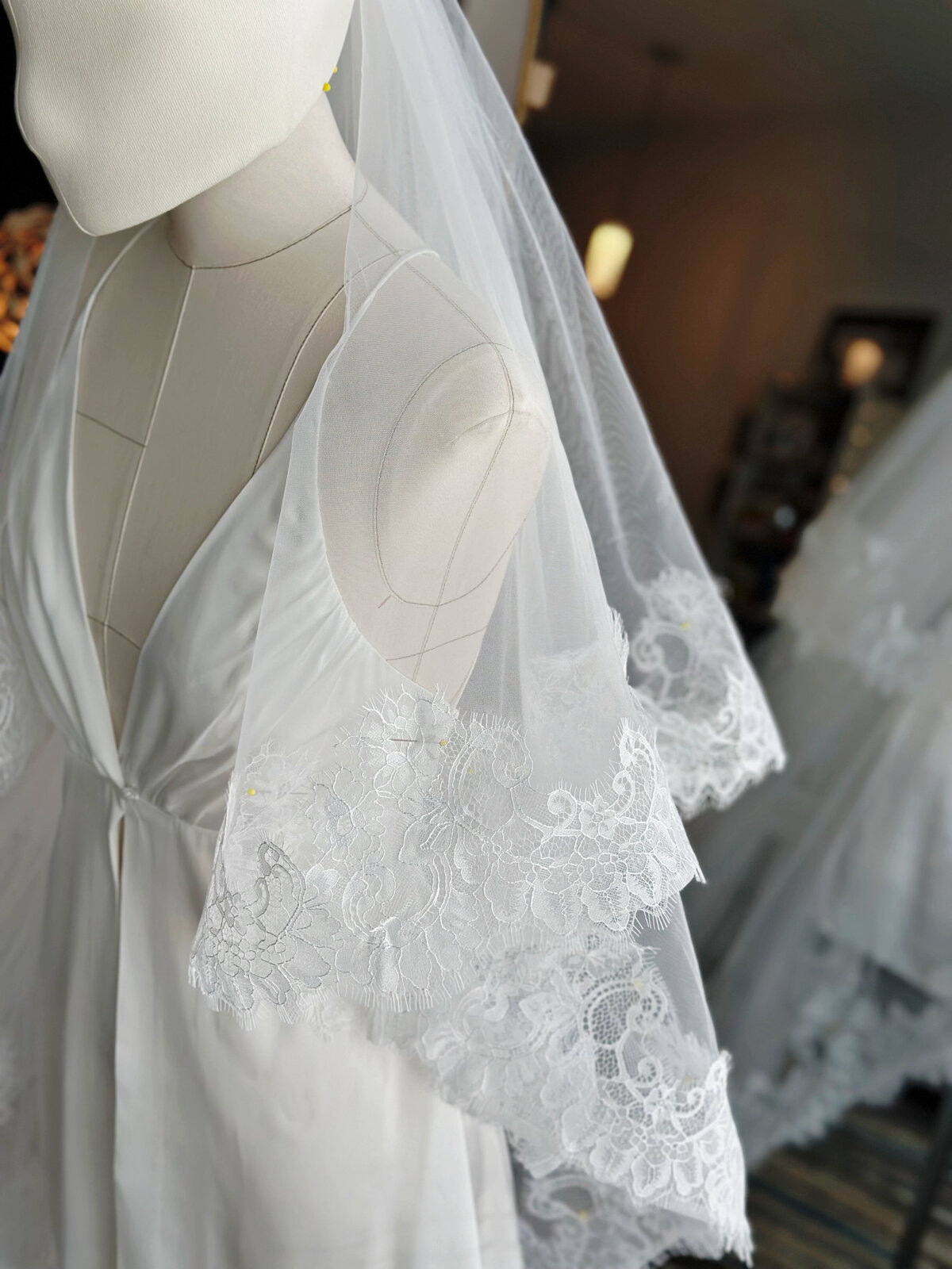 Elegant blusher veil featuring hand-sewn floral lace border
