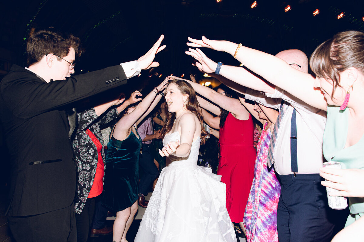 A couple shares a dance with their guests during their reception at the Garfield Park Conservatory in Chicago