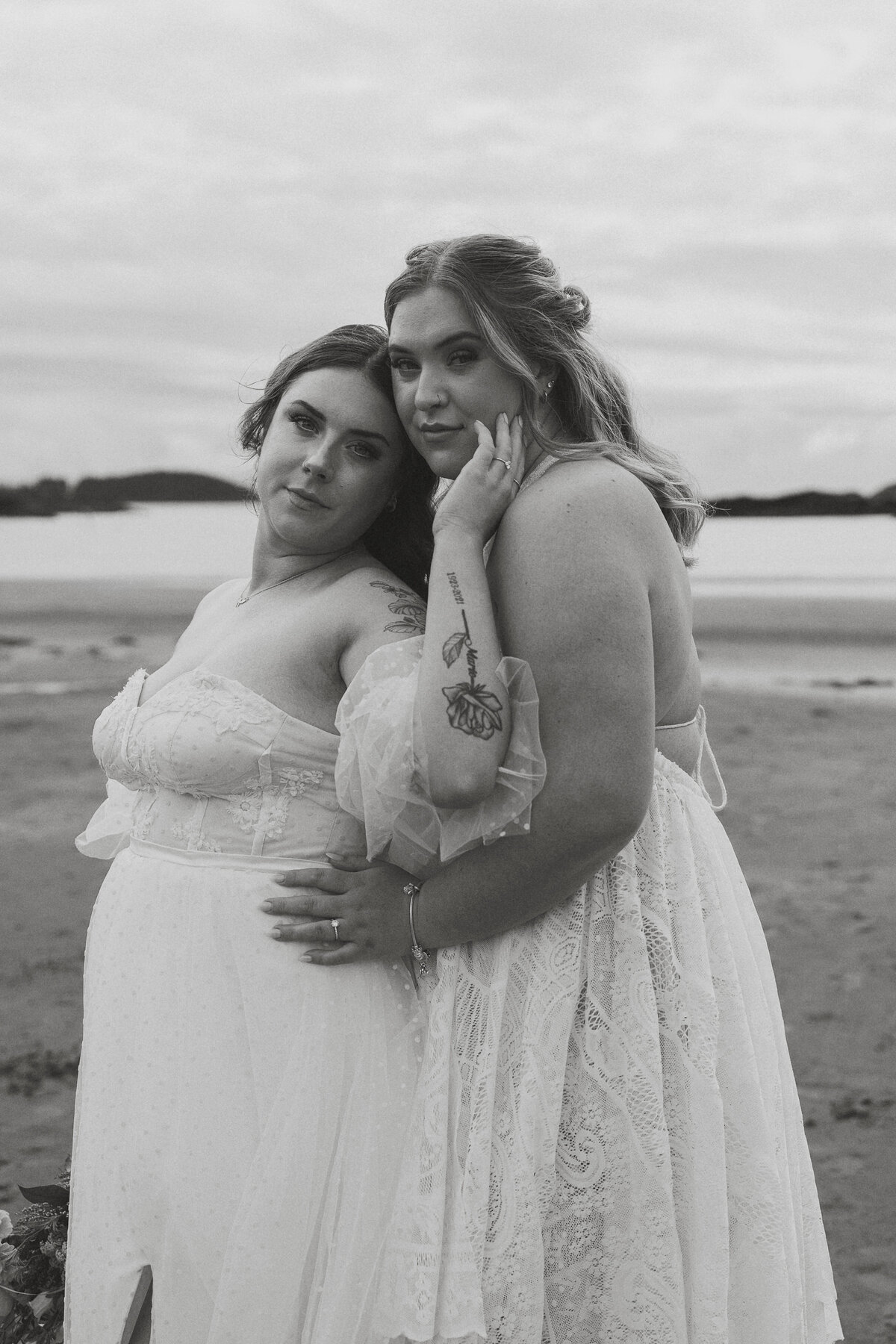 Two brides during their elopement photos on Mackenzie beach in tofino by latitude 49 photography