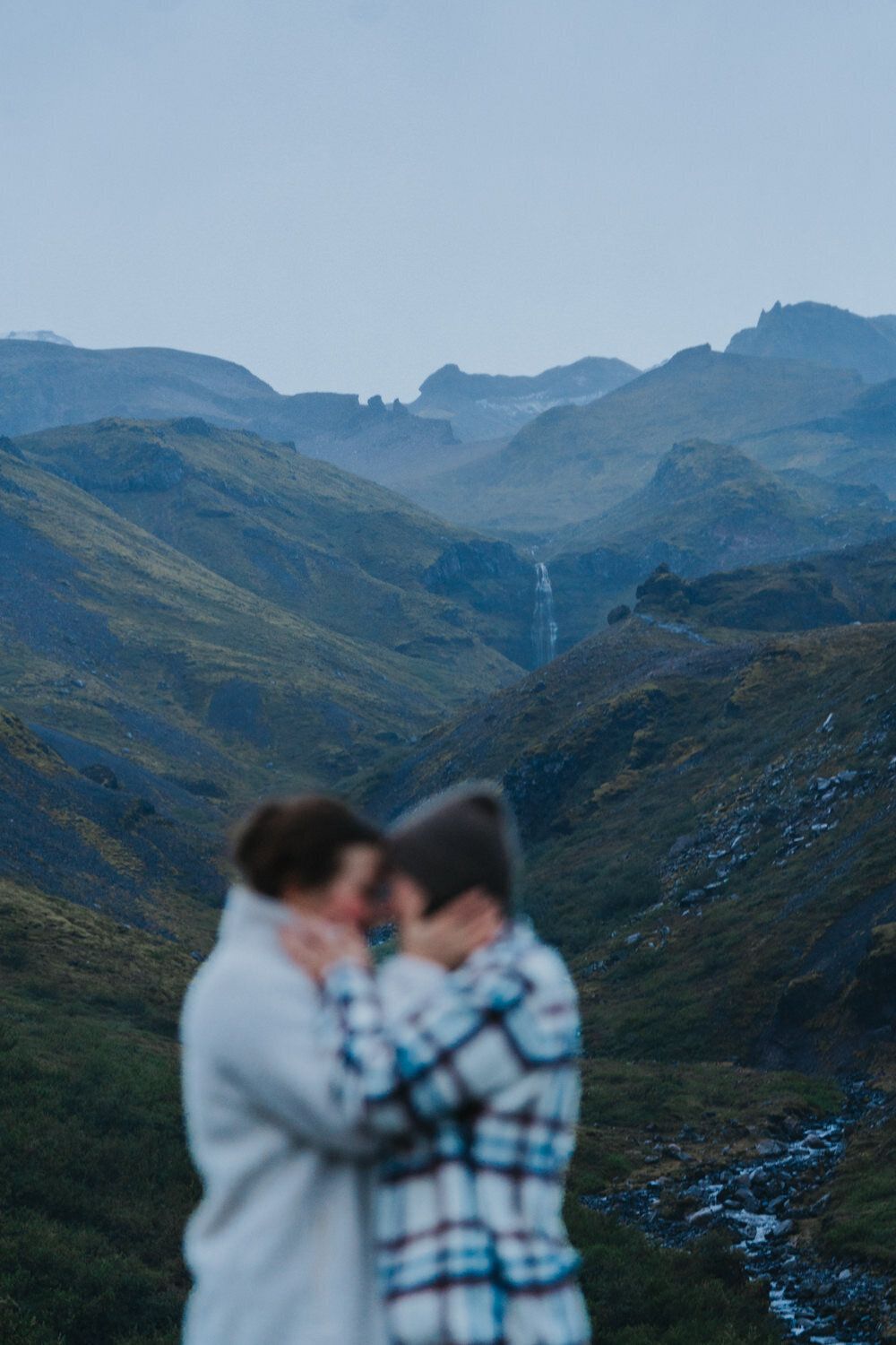 Women grab each other's faces and prepare to kiss 