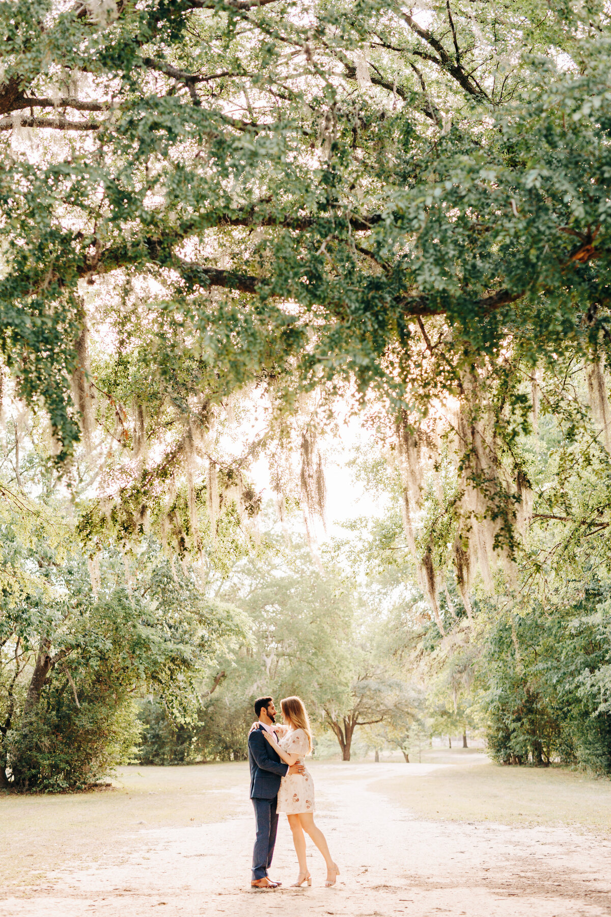 couple under a gorgeous tree at Terry Hershey Park in Houston, TX