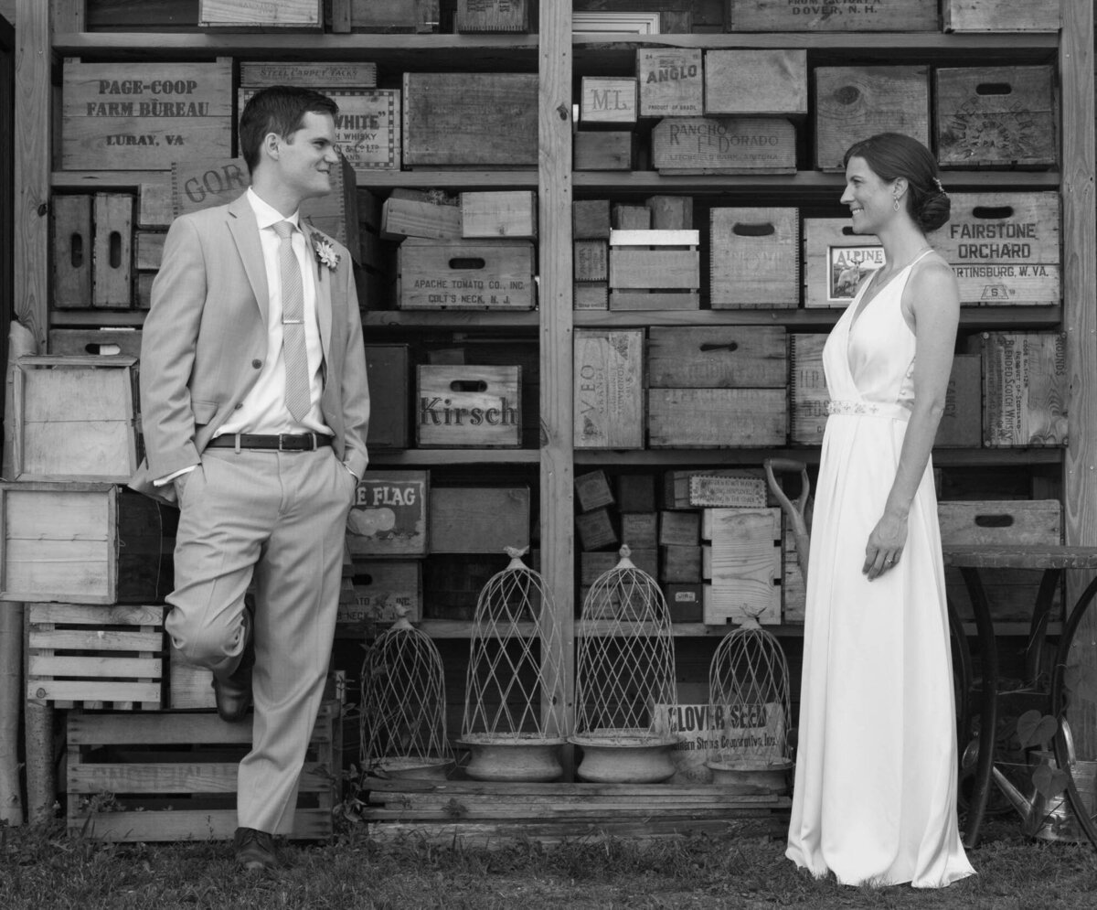 Bride and groom looking at each other in the barn