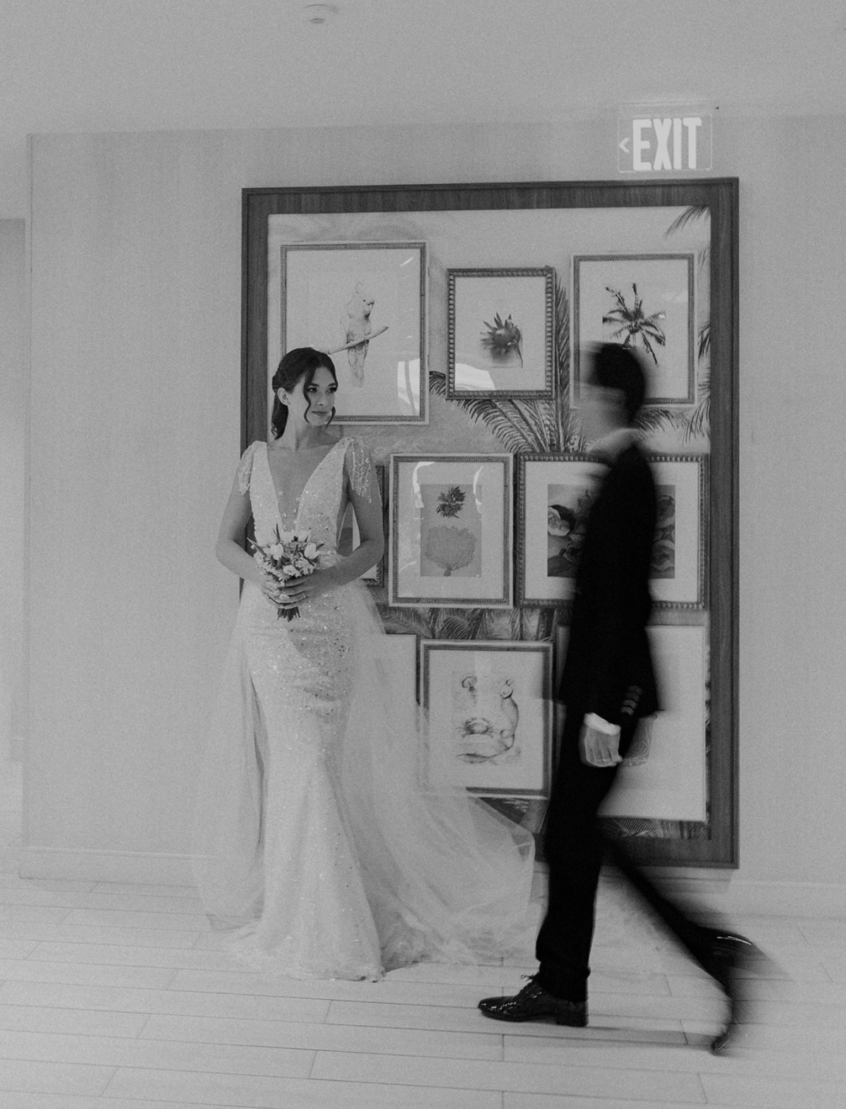 Bride in a beaded gown holding a bouquet, with groom walking past, captured by Claudia Amalia, a wedding and lifestyle photographer based in Miami and Florida Keys, South Florida. Destination weddings available. Portfolio highlight.