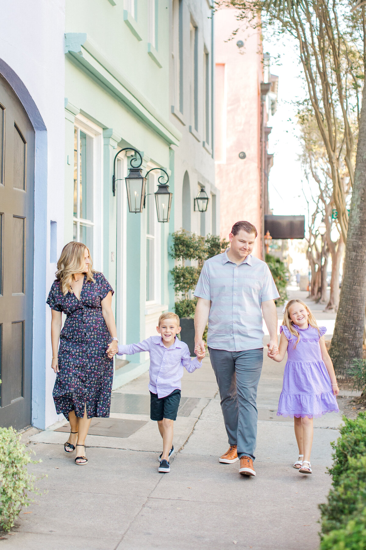 Family walks together down Rainbow Row in South Carolina by Karen Schanely
