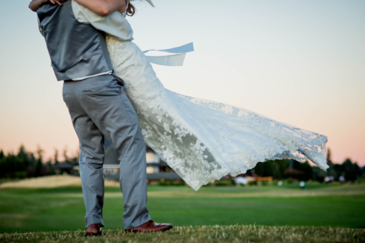 Oregon Golf Course Wedding Venue Groom Swinging Bride