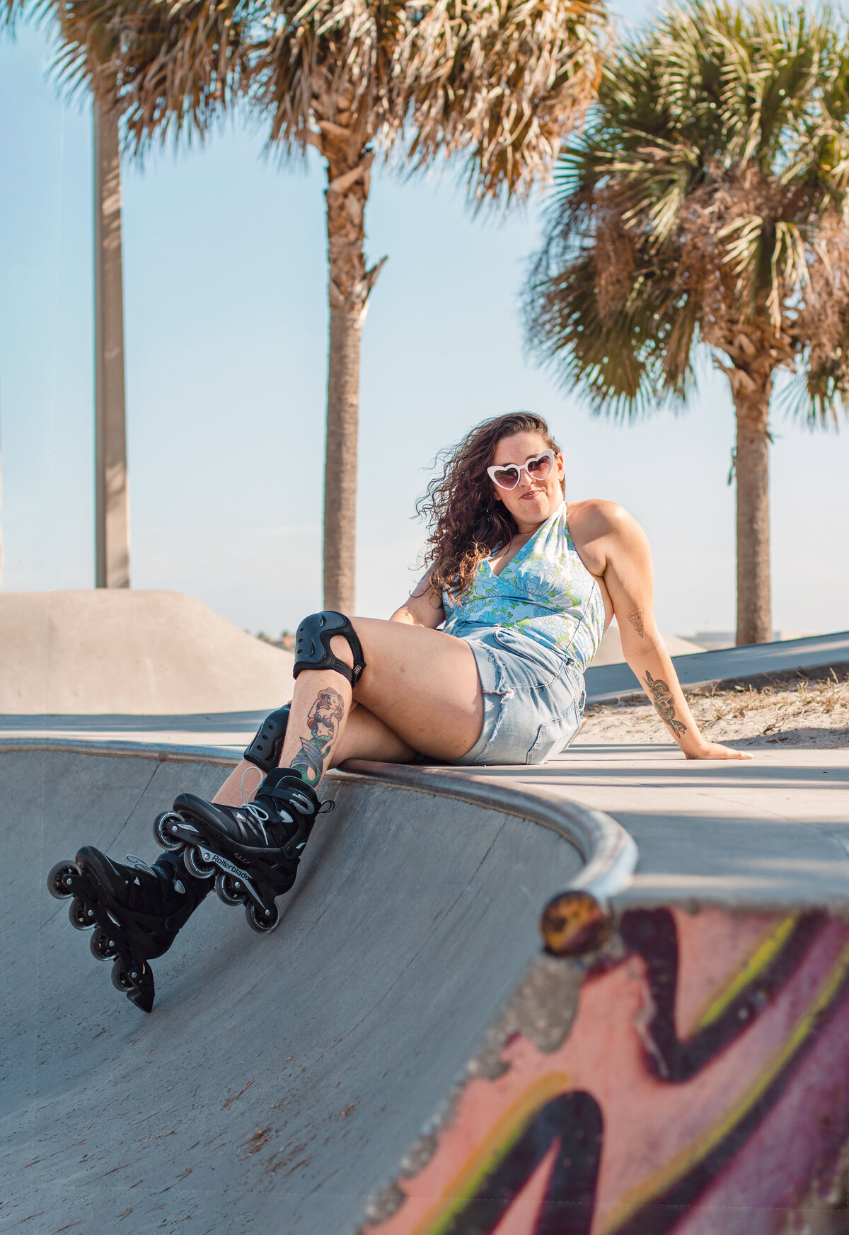 Model sits at tropical skatepark in Bradenton Florida while wearing rollerblades