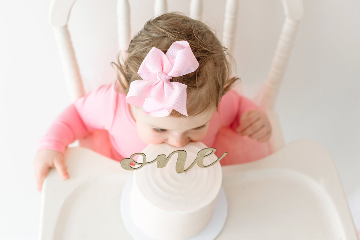 baby girl diving into cake