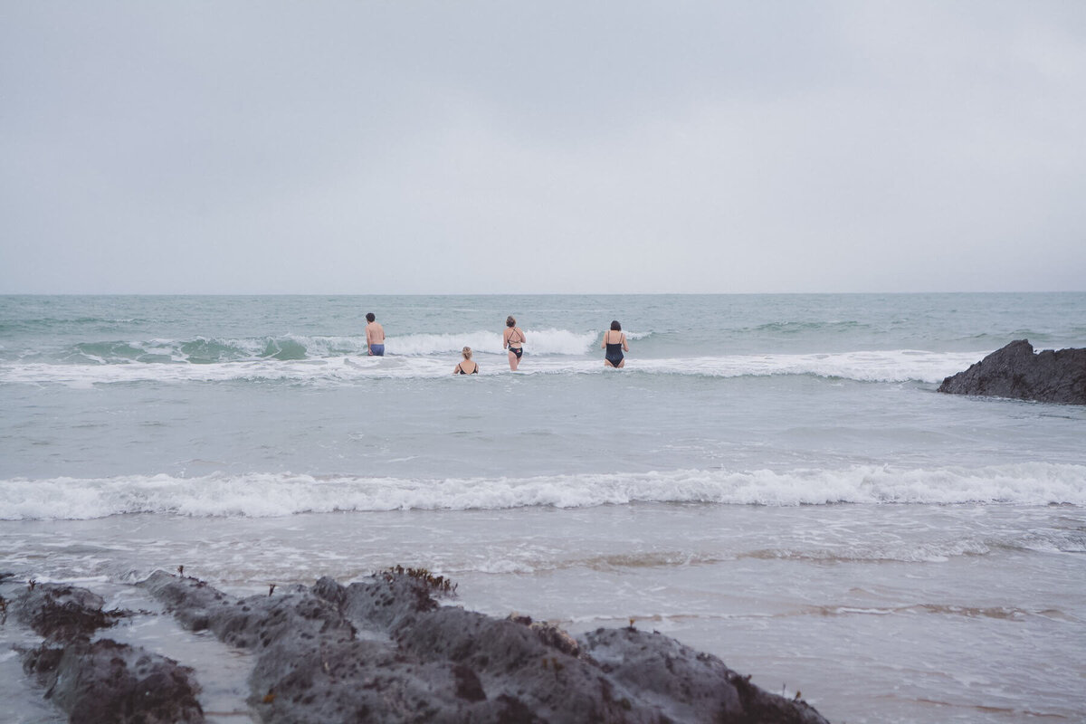 A group of people swimming in the sea