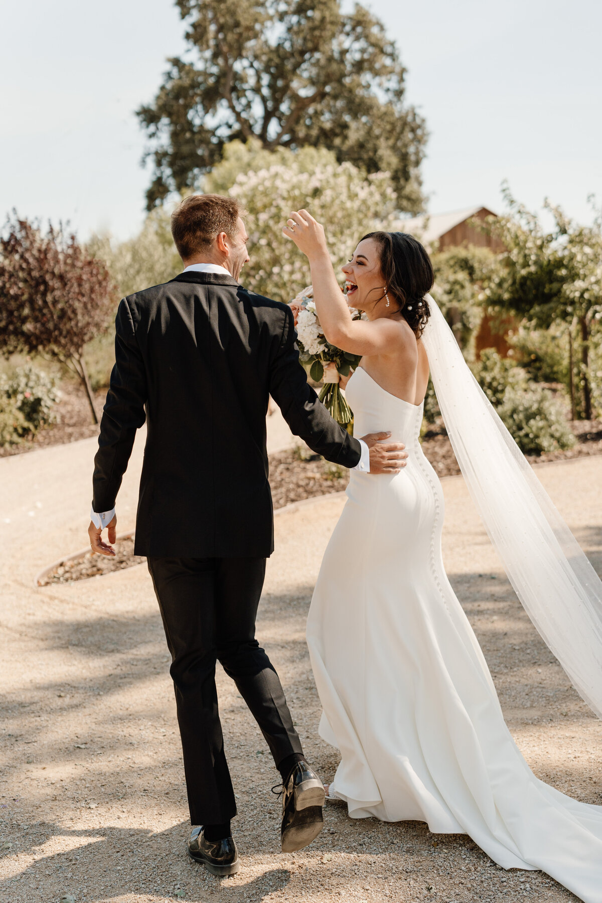 bride and groom walking away on wedding day