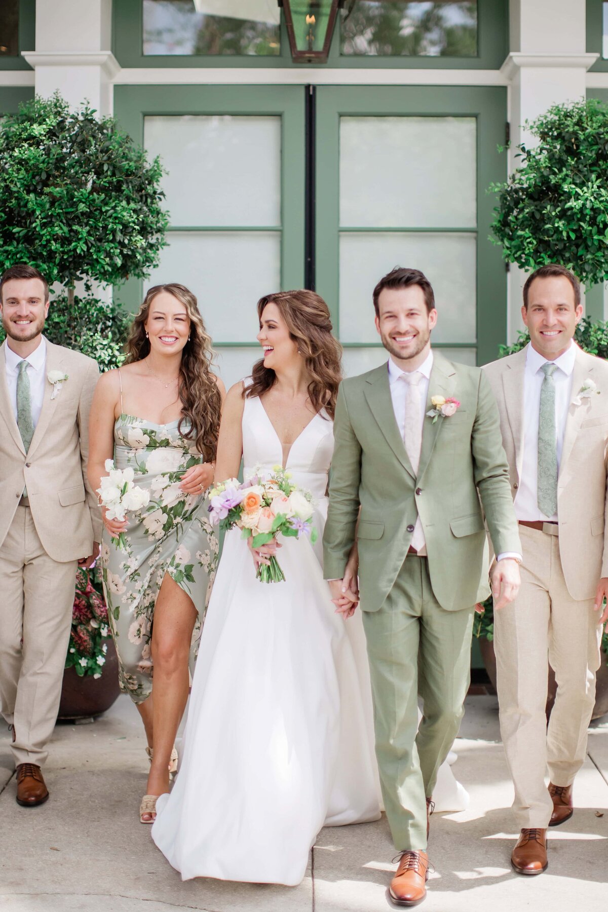 couple walking with wedding party