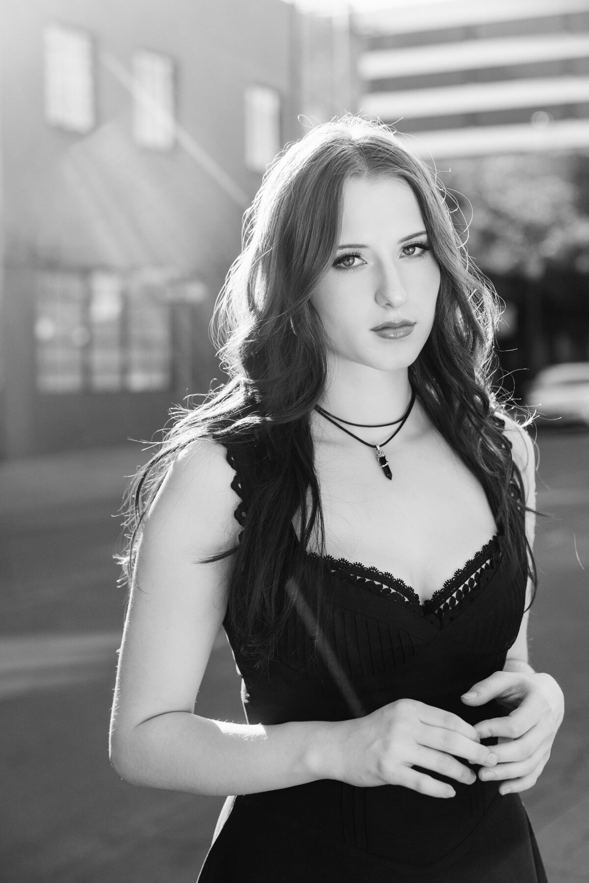 Black and white senior portrait of stylish teen in black corset top with vintage film noir vibes taken in downtown Pasadena, California