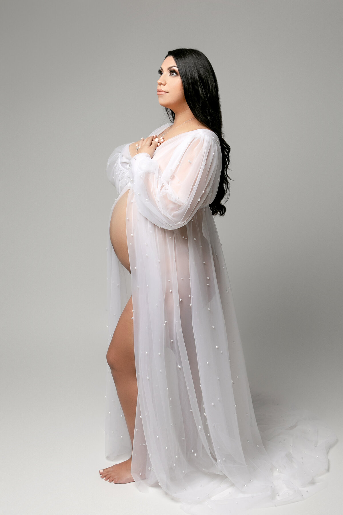 Beautiful woman in a pearl adorned white gown during an intimate photoshoot with One Good Shot Photography