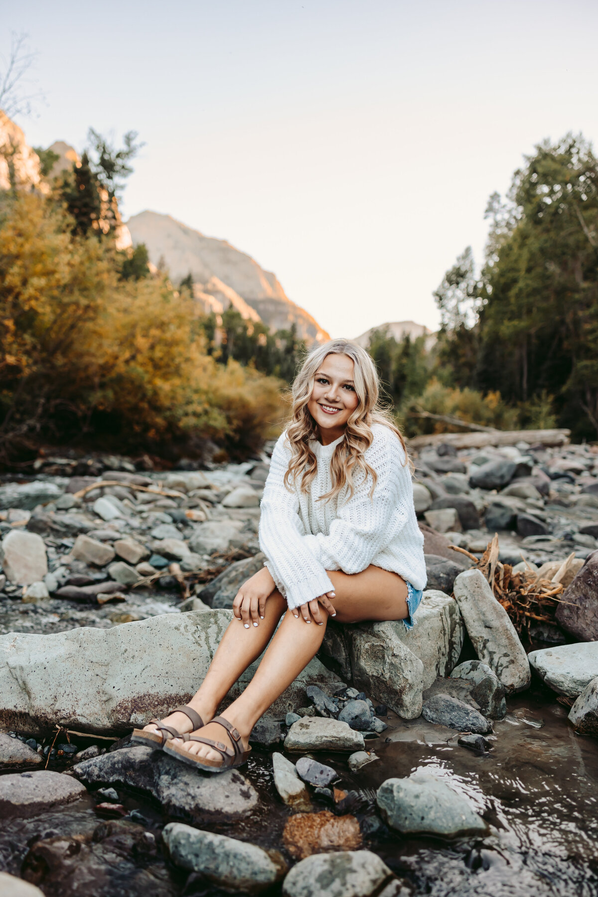 Jordyn poses in a river for her Telluride senior pictures.