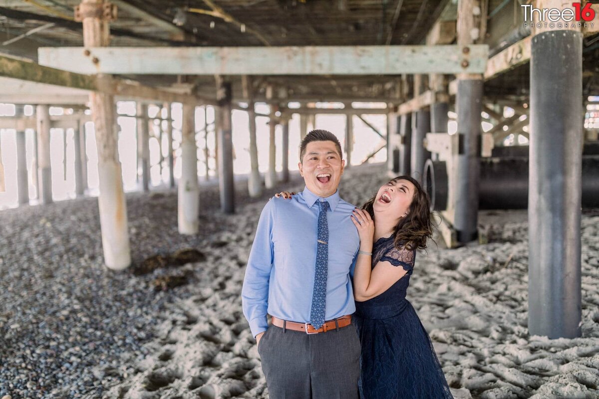 Engaged couple are in a laughing fit during photo session