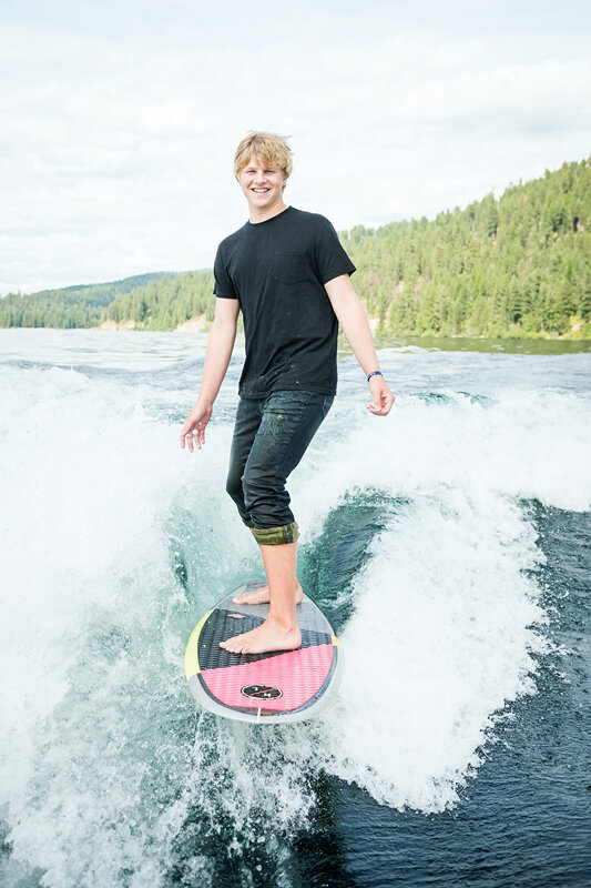 senior boy on surf board