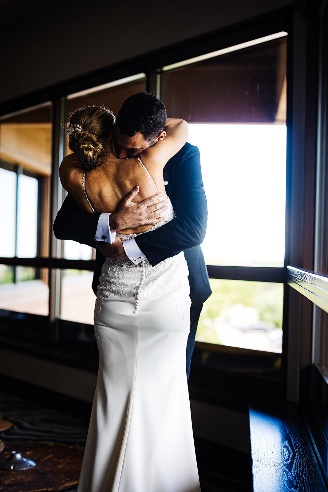 Bride and groom share a first embrace on their wedding day.