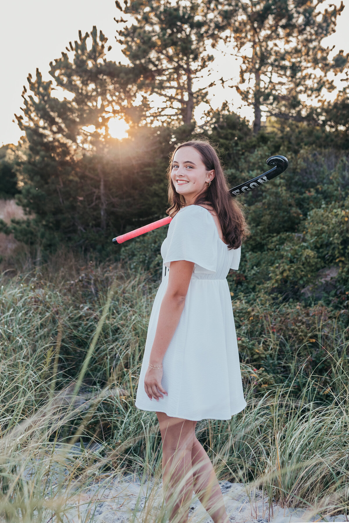 girl senior photo with field hockey stick