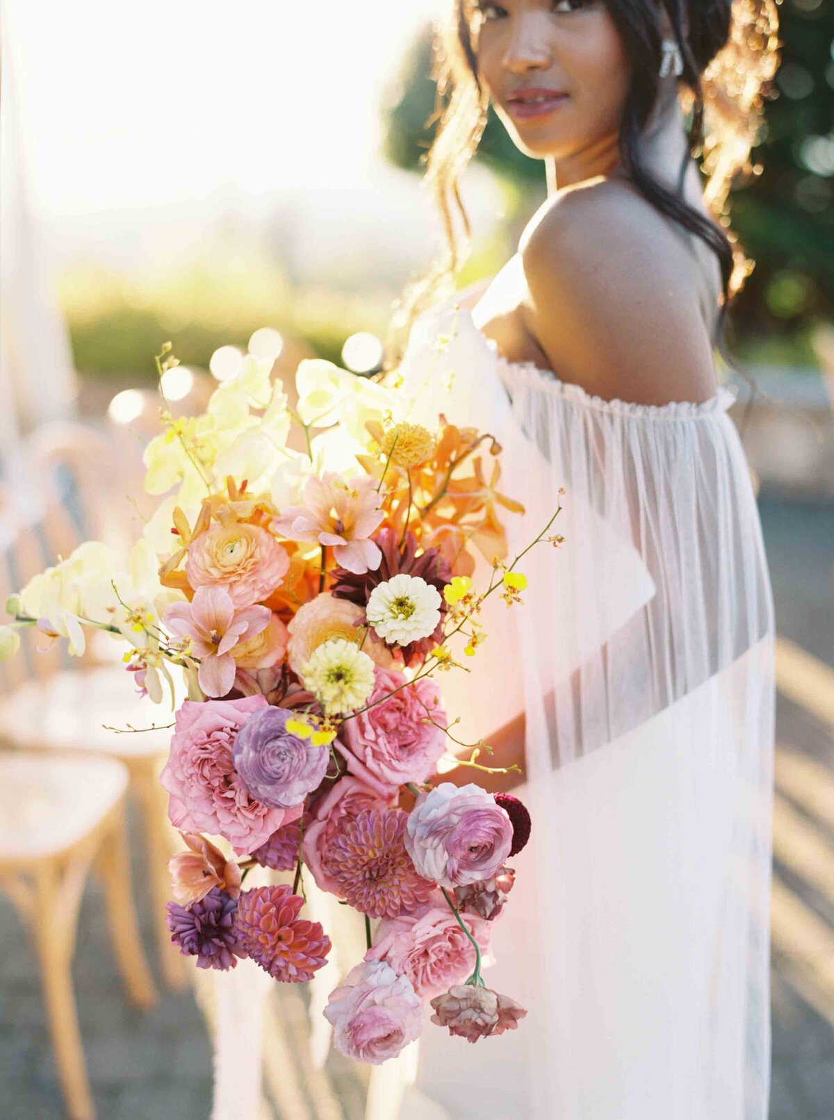 film photo of bride holding colorful large bouquet
