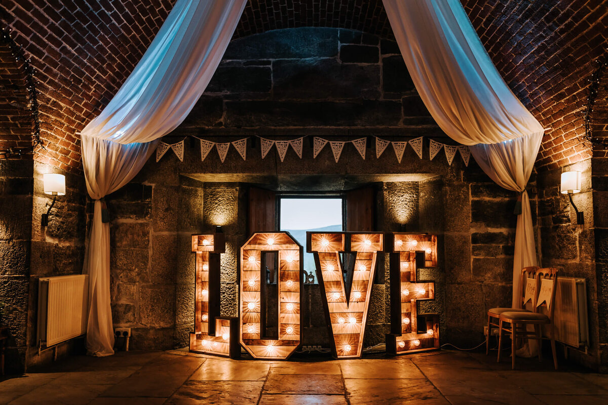 A lighted love sign in the middle of a room