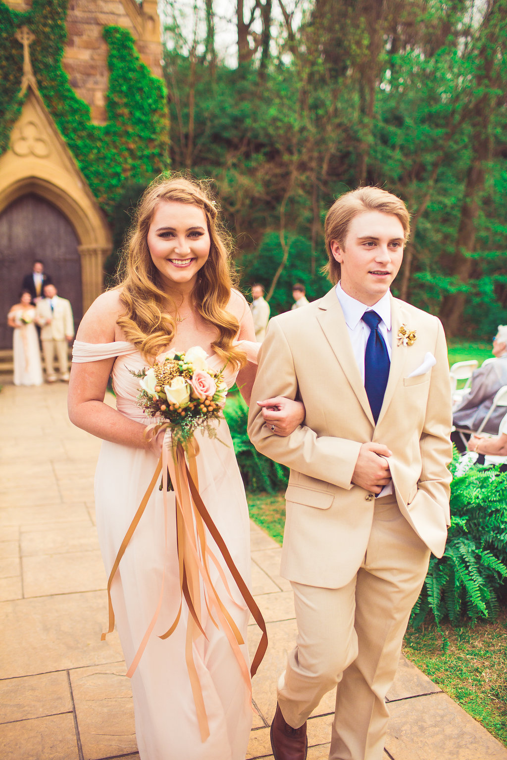 Wedding Photograph Of Woman in Peach Dress and Man in Light Brown Suit Walking Down The Aisle Los Angeles