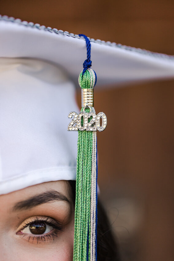 senior girl in white cap with tassel