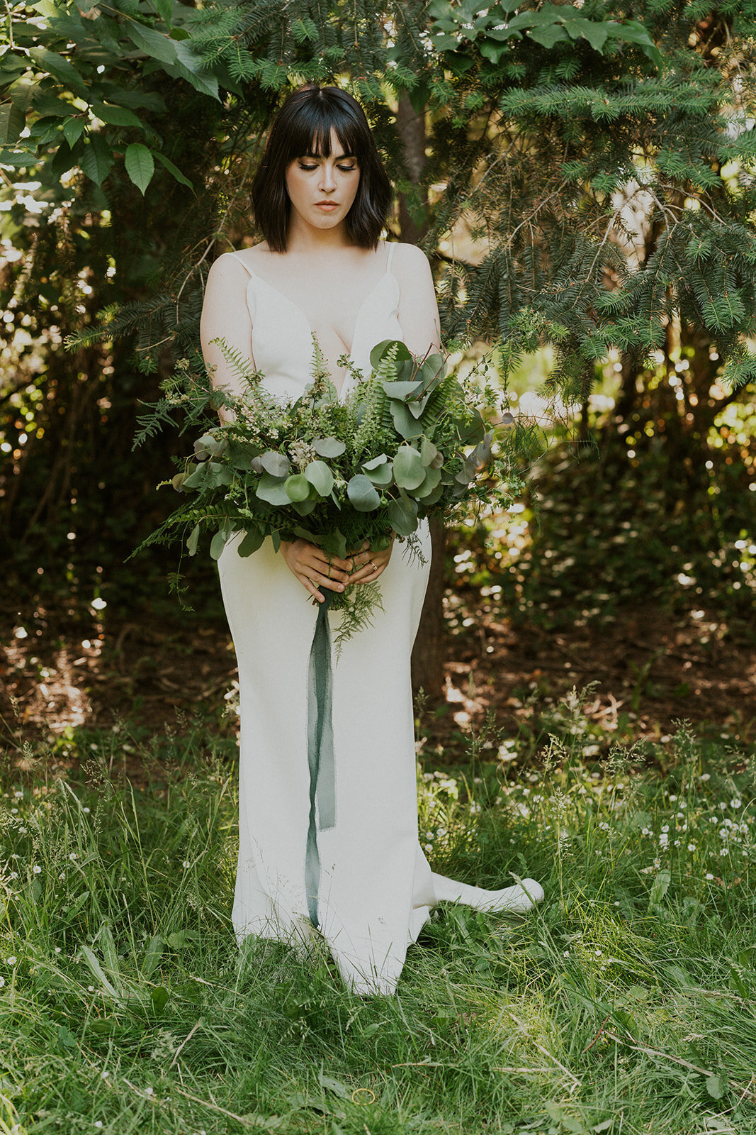 the-bride-with-a-bouquet-in-the-forest