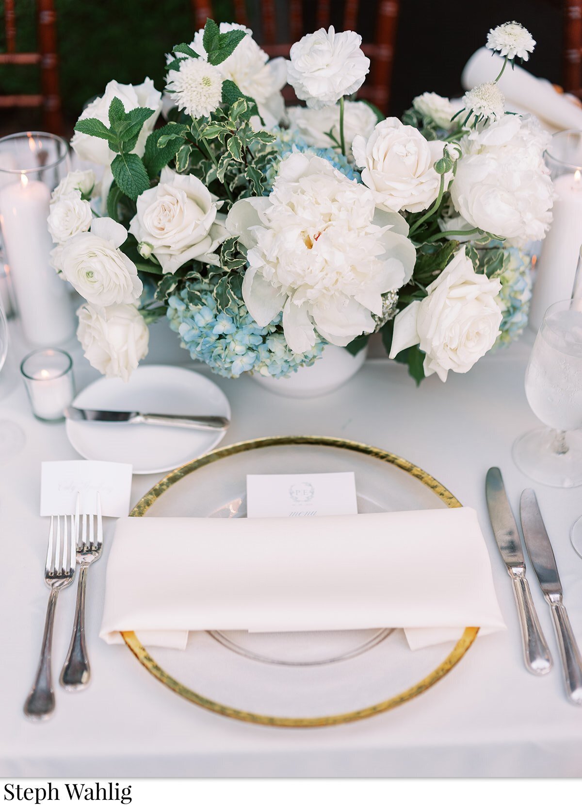 table setting, white linens, white flowers, blue accents, arrangements