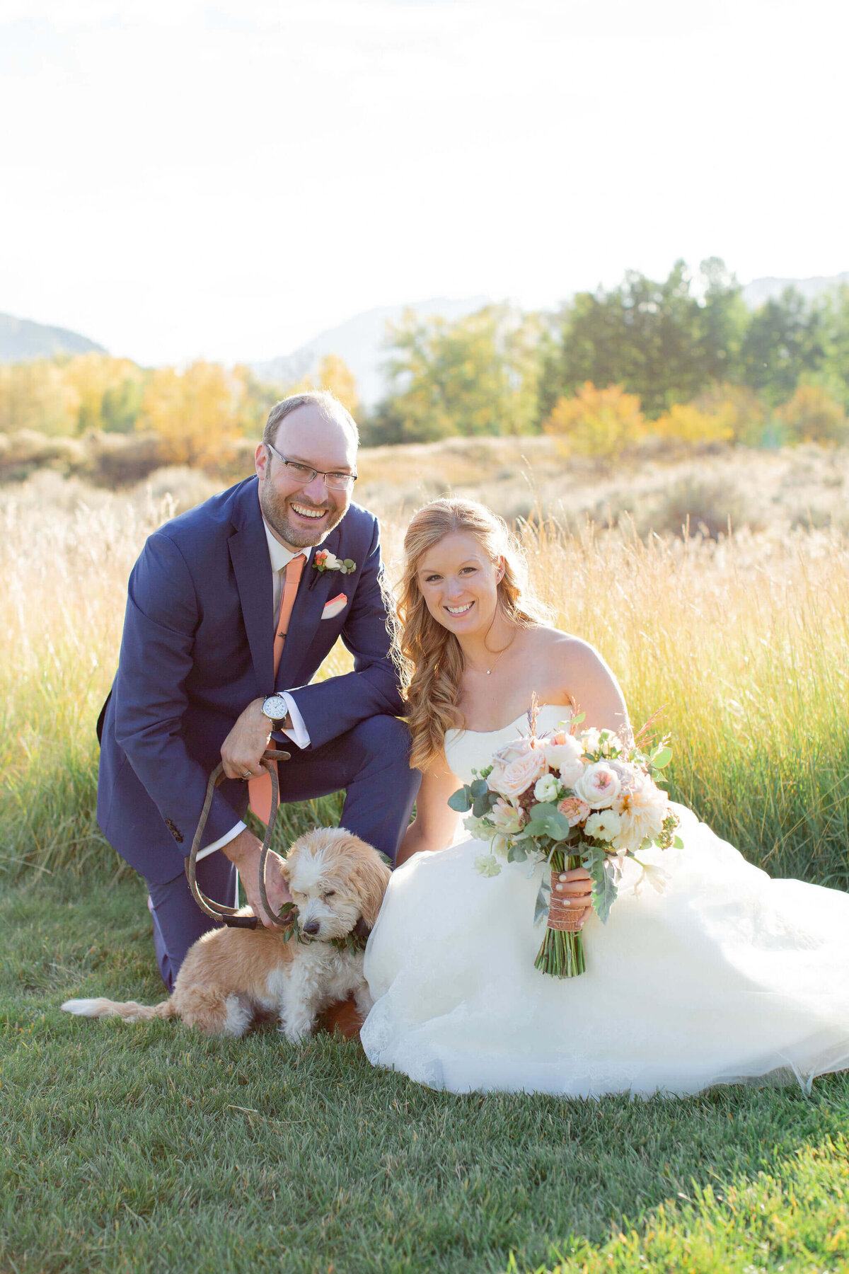 smiling bride and groom with their dog