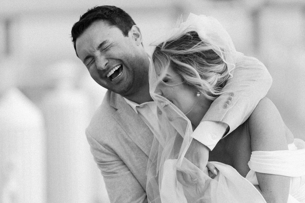 A candid, joyful moment between Monica and Austyn, captured in timeless black and white.