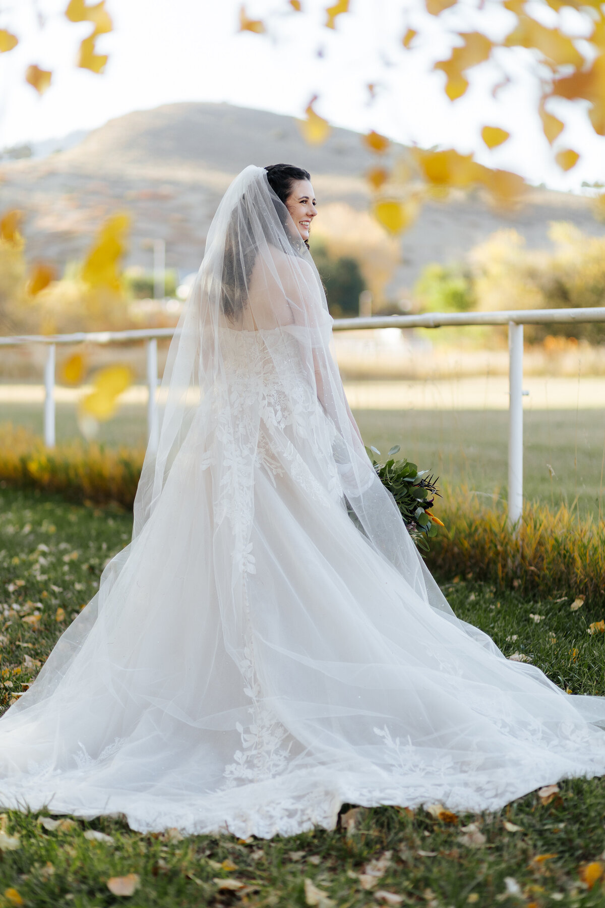 A bride poses for a photo during her wedding at Ellis Ranch Event Center in Loveland Colorado.