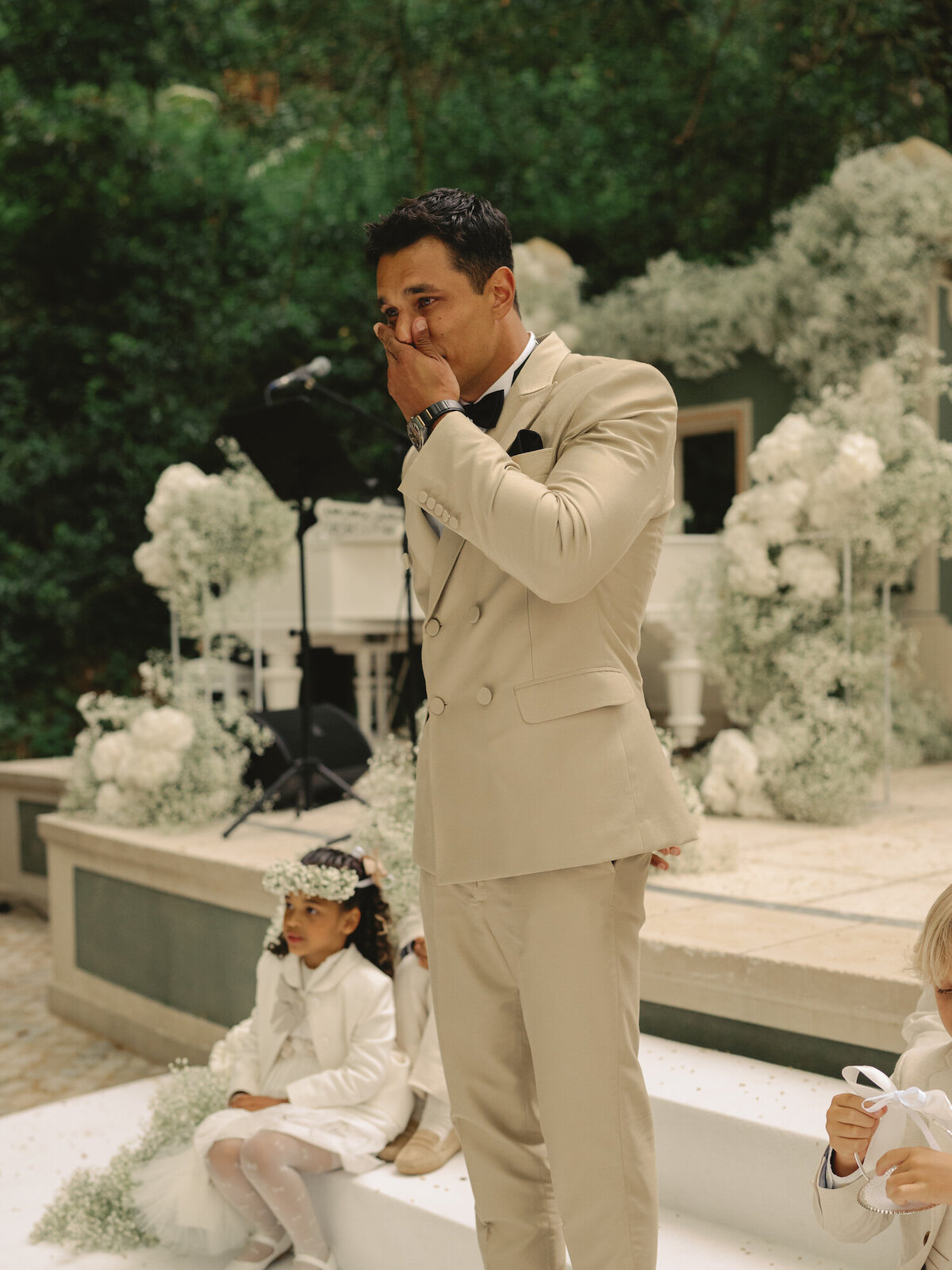 The groom is crying when he sees his bride walking down the aisle on their Quinta da Bellavista destination wedding