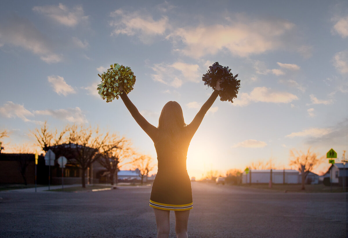 Senior Cheerleader against sunset in Kress Tx