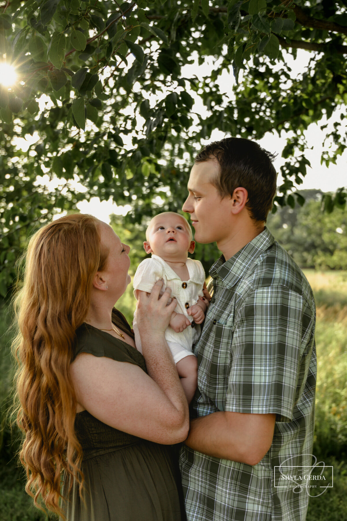 Young family together in Troy Ohio park