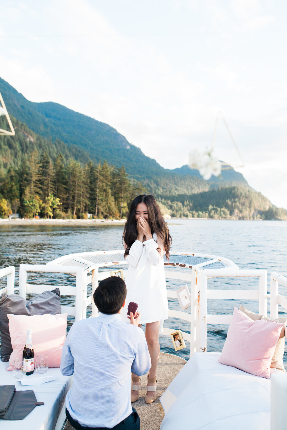 man kneeling to propose at porteau cove