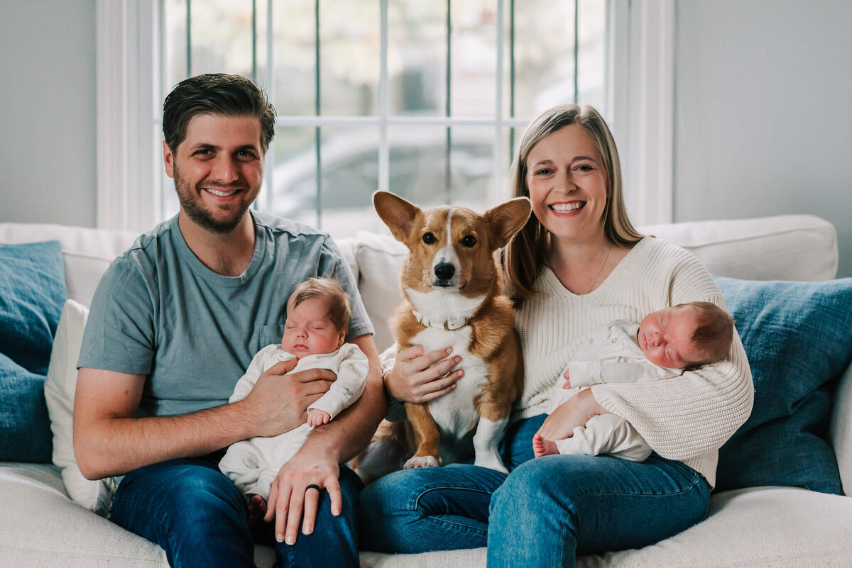 Parents holding newborn twins and corgi by Denise Van, a Nothern VA newborn photographer
