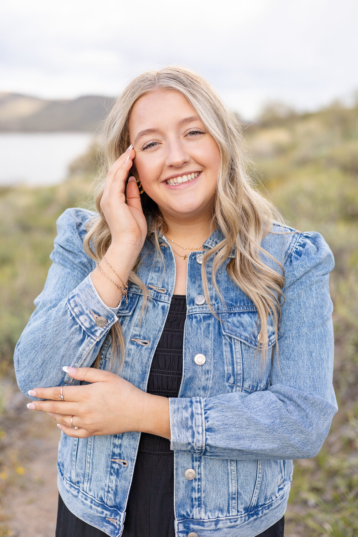 Senior girl smiles during a senior photography session at Lake Pleasant in Peoria, Arizona.