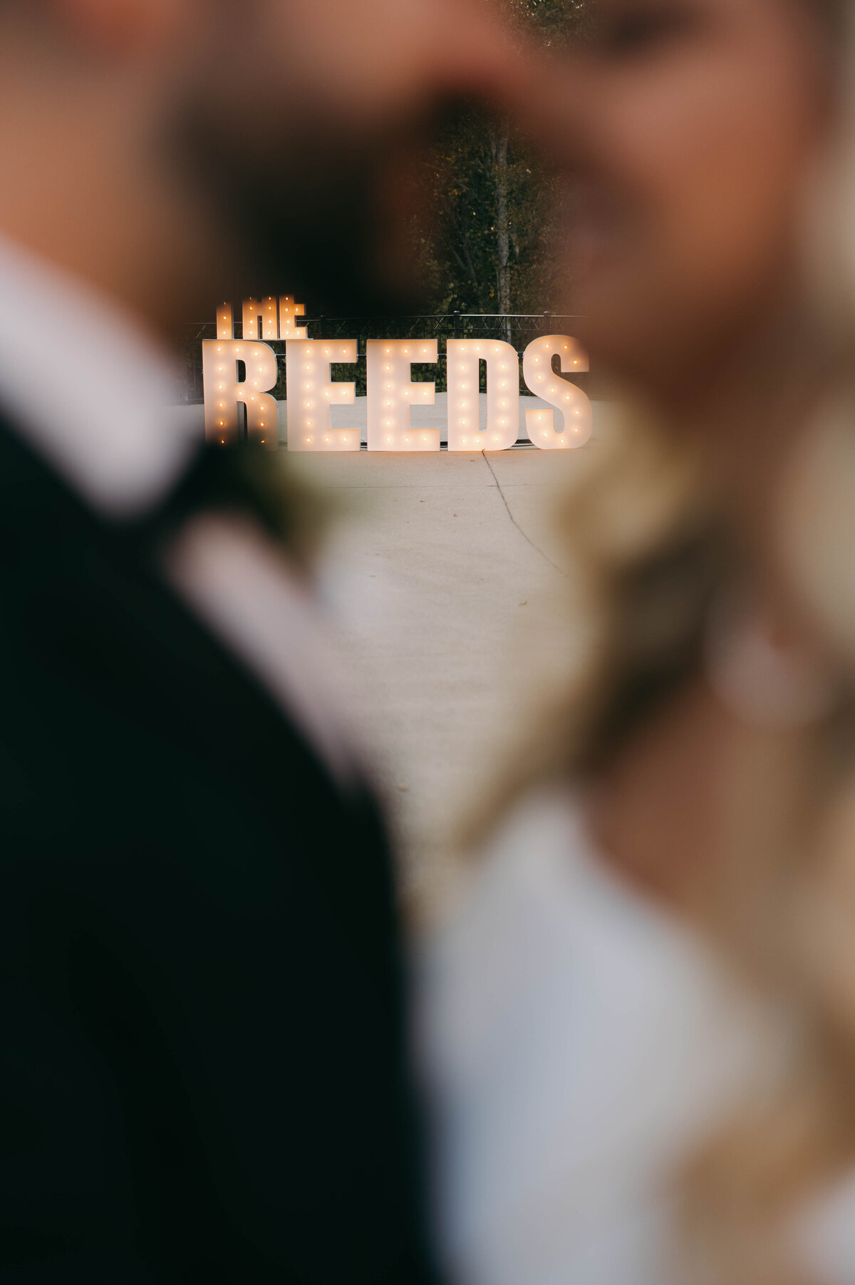 marquee letters between bride and groom