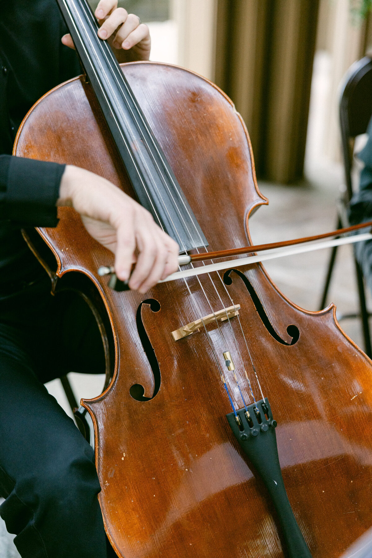A wedding day photo of a violinist playing during the wedding ceremony