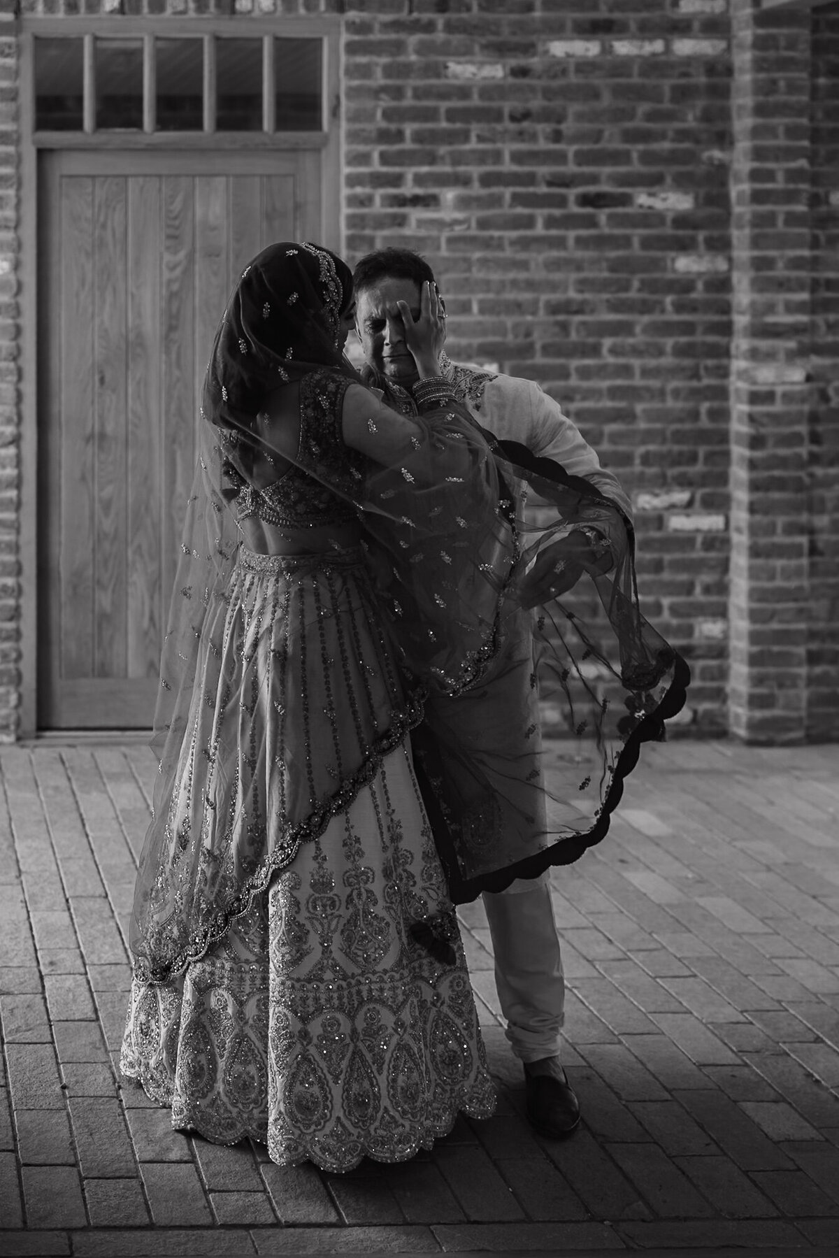 Wedding photographer captures couple taking a stroll hand in hand at their french chateau wedding.