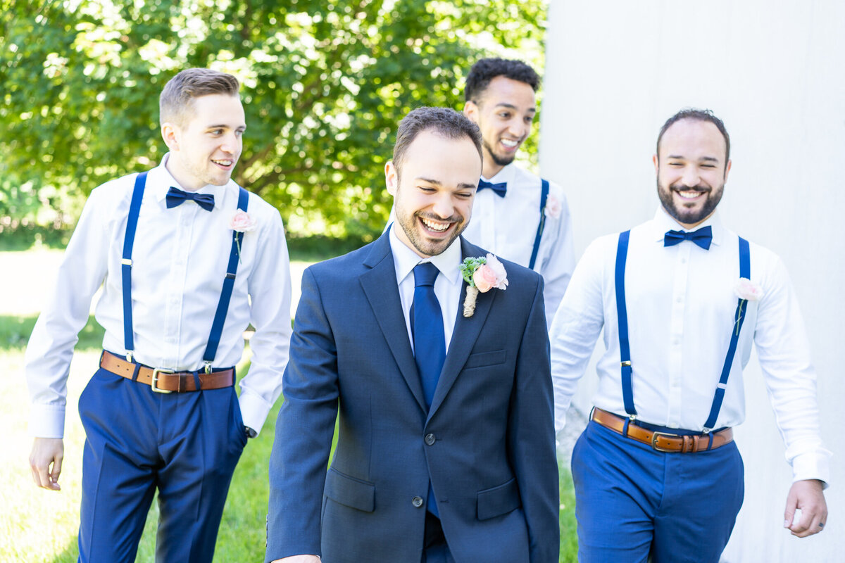 The groom, Mitch Chatto, and his groomsmen walking outside at Mitch's intimate church wedding in Delaware, Ohio.